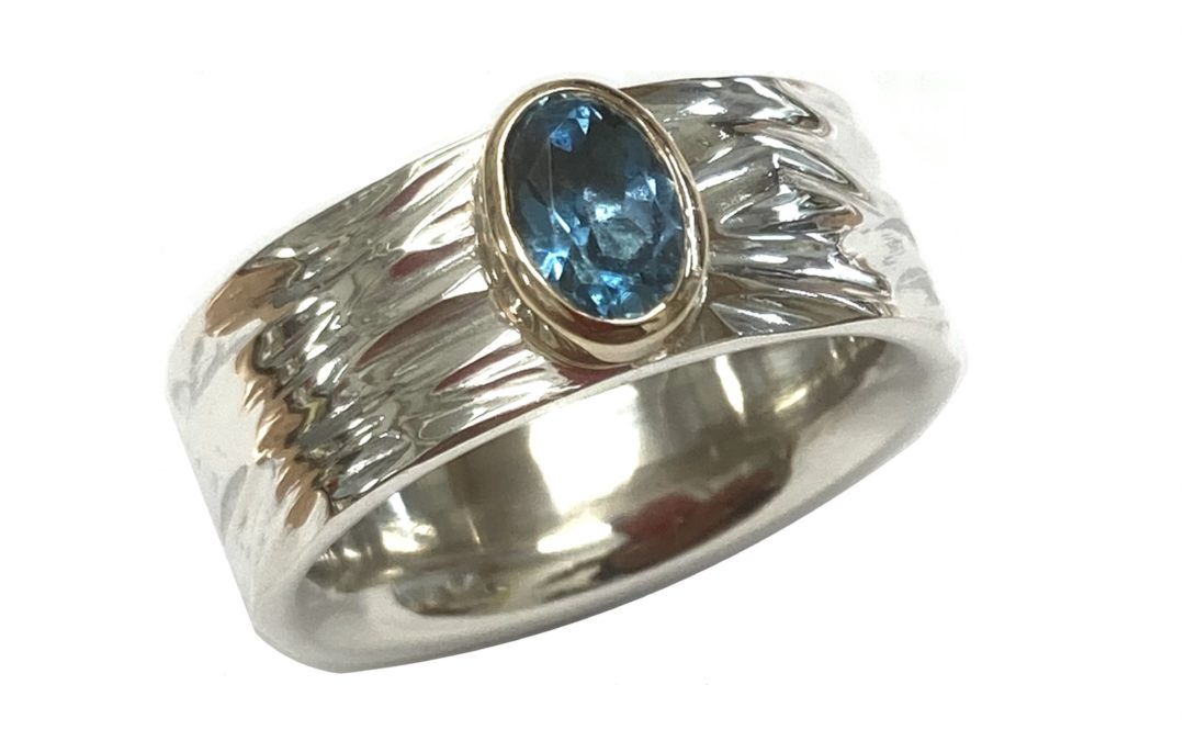 Silver and gold blue topaz ring