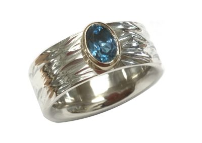 Silver and gold blue topaz ring